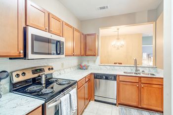 A kitchen with a stove and a wall with geometric patterns